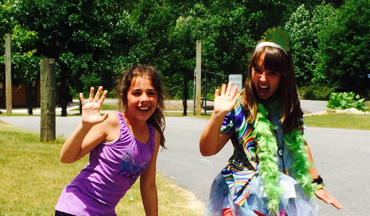 Amelia Oliver as a young girl enjoying camp with a Camp Twin Lakes volunteer. 
